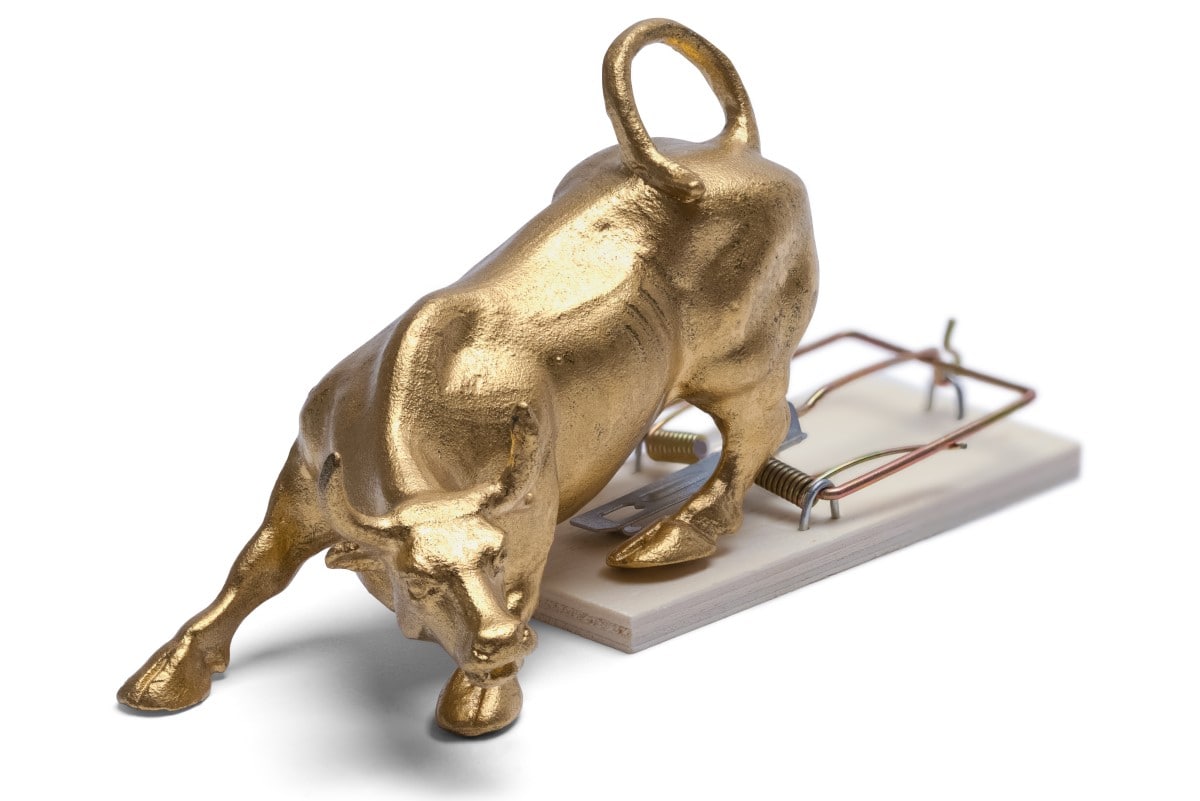 brass bull on trap isolated white