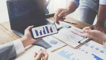 Empresarios analizan gráficos del ciclo económico del país donde pretenden hacer sus inversiones.